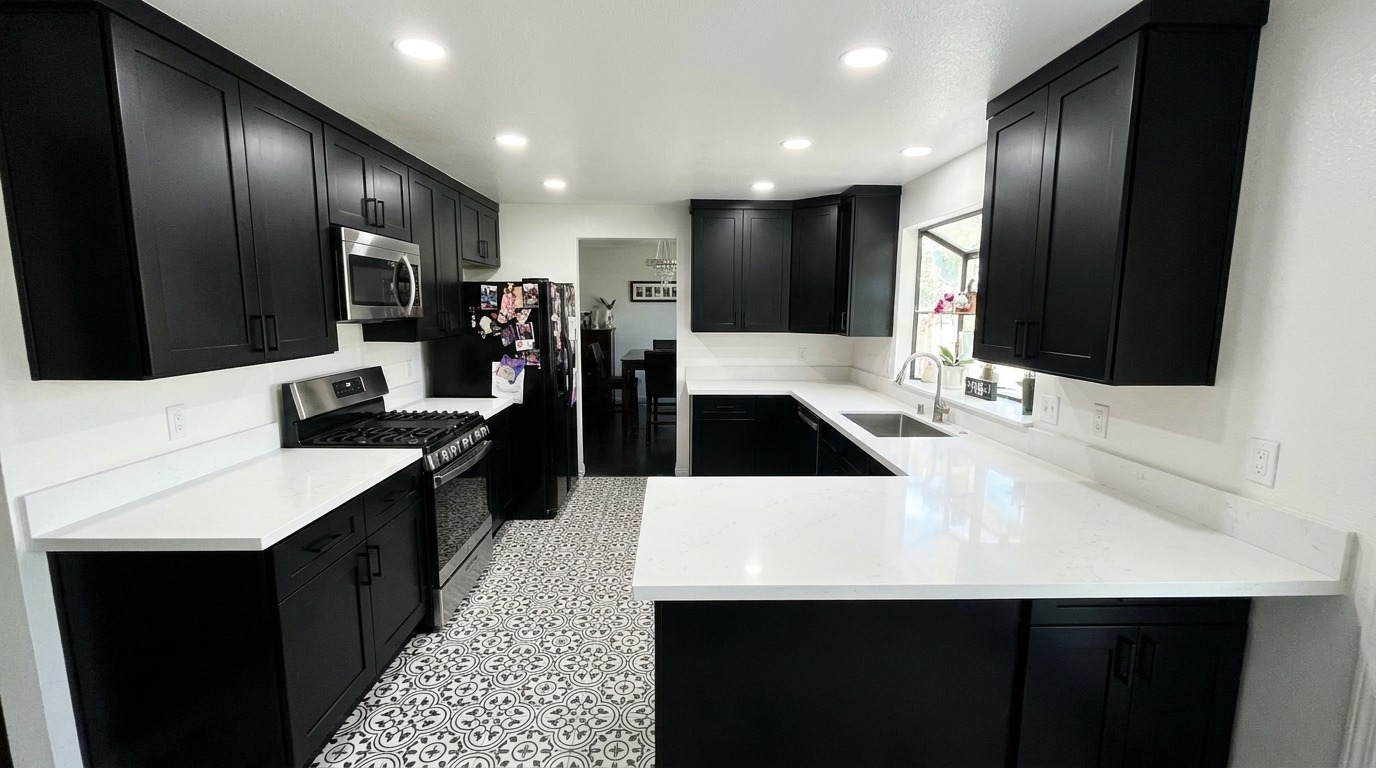 Modern black shaker kitchen with patterned tile floor and stainless appliances